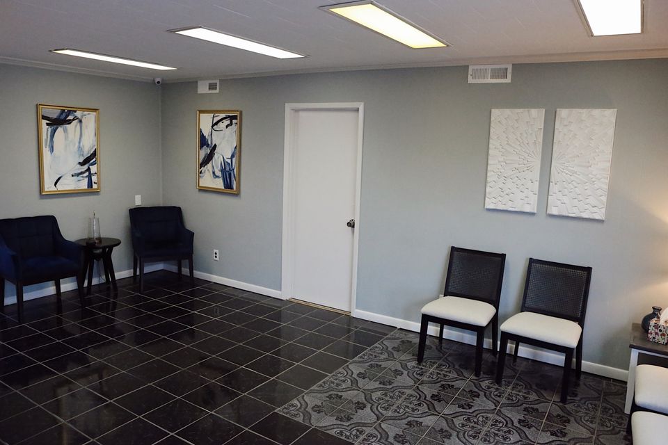 Chairs and framed art in the Hope Center waiting room.